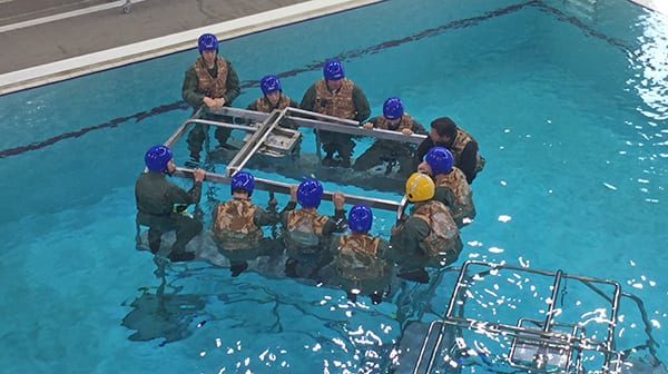 Briefing in the pool prior to using Short-Term Air Supply Systems (STASS) personal air bottles.