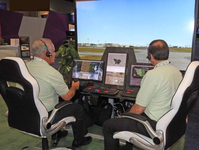During 2017 I/ITSEC, John Merwin (left) and Nick Papadopoli (right) demonstrated Adacels's ATCiB Simulated ATC Environment for delegates.
