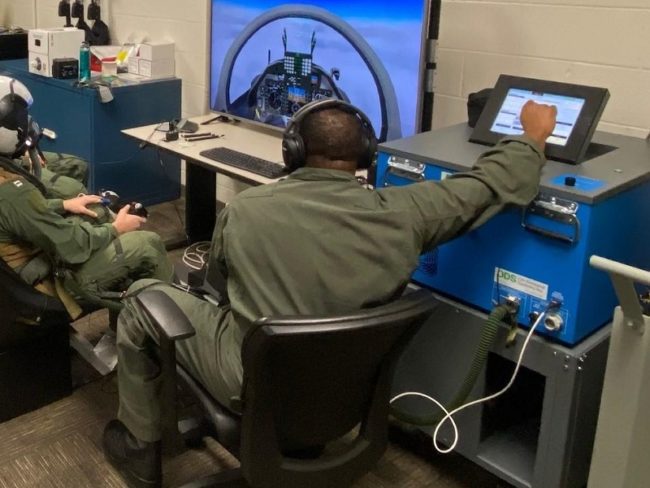 Navy Installs Mask on Breathing Device Trainer