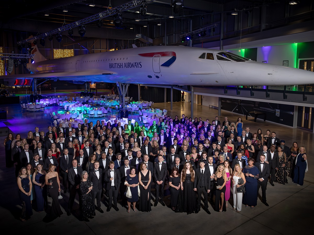 2. group photo of all guests with backdrop of concorde aerospace bristol.